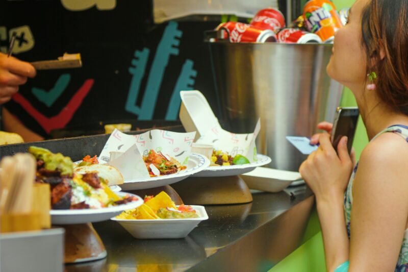 Food on plates being served up on the side of a food stall